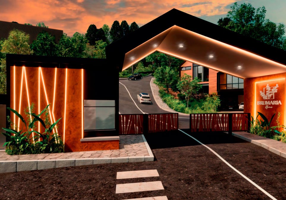 Entrada principal del condominio residencial Brumaria con portería moderna, iluminación arquitectónica y acceso vehicular
