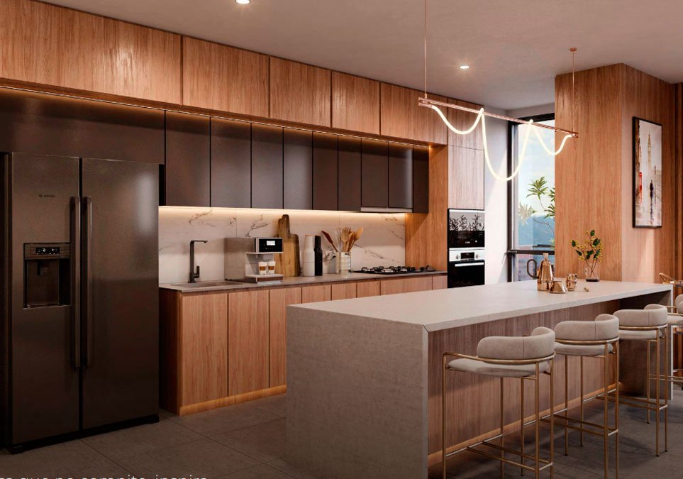 Cocina moderna de un apartamento del proyecto Treebal Medellín, con isla amplia, muebles en madera, electrodomésticos integrados y diseño contemporáneo.